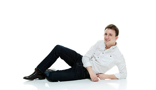 istock Smiling man lying on floor and looking at camera 500781148