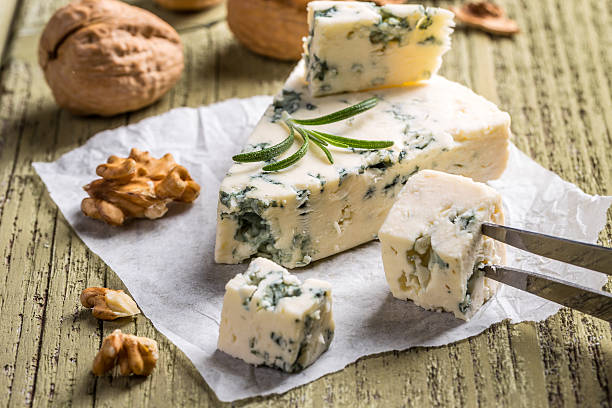 Cheese with mold Cheese with mold on wooden background blue cheese stock pictures, royalty-free photos & images