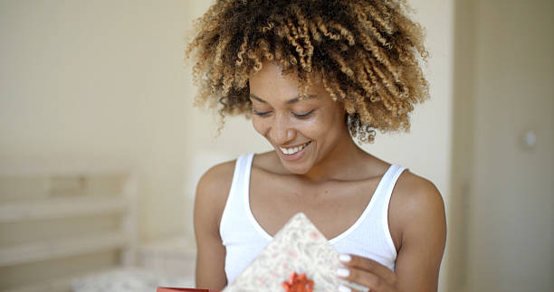 istock Happy Young Woman Open Gift Box In Bedroom 500784214