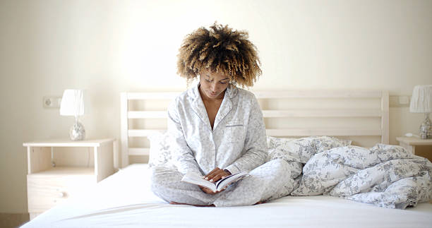 istock Woman Reading A Book On Bed 500784460