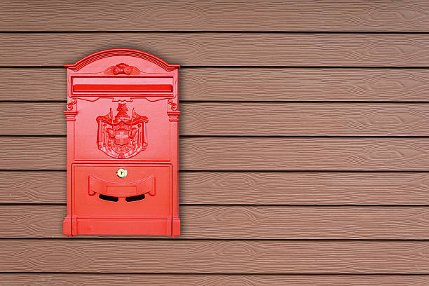 istock Red mailbox with wooden background with copy space 500785536