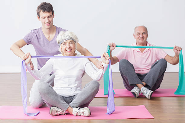 istock Mature couple with personal trainer 500785742
