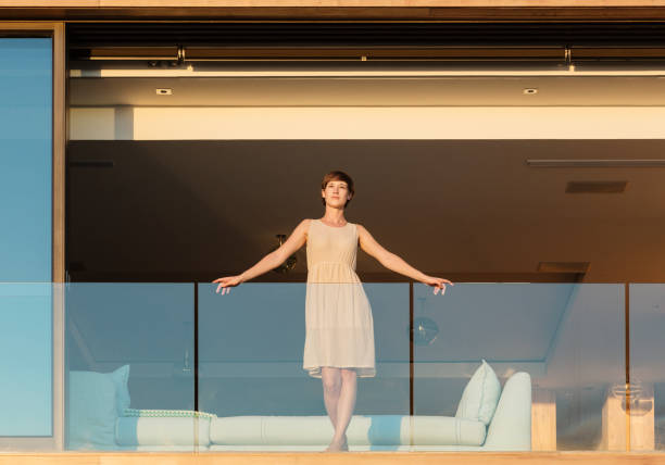 istock Woman standing on luxury balcony 500786247