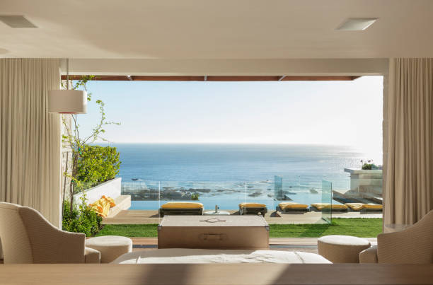 istock Sunny bedroom and patio overlooking ocean 500786273