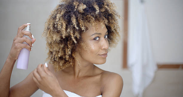 istock Woman Using Hair Spray In Bathroom 500786904