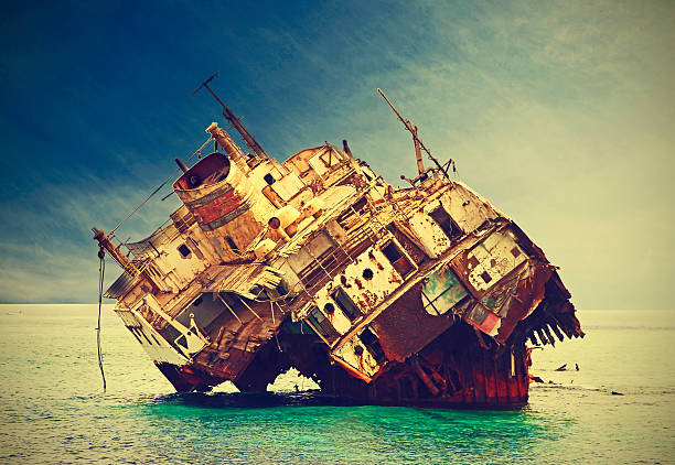 the sunken shipwreck on reef, vintage filtered. - iron sheik stockfoto's en -beelden