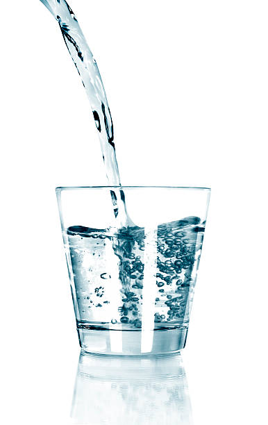 istock water pouring in glass isolated on white background 500790663