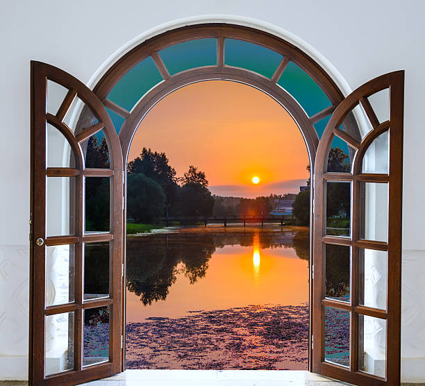 istock open door with  view green meadow illuminated by bright sunshine 500791427