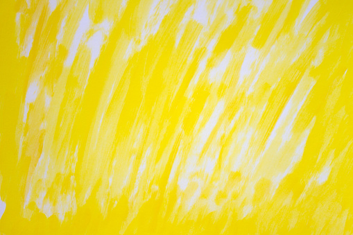 Abstract art hand-painted background in lemon yellow color