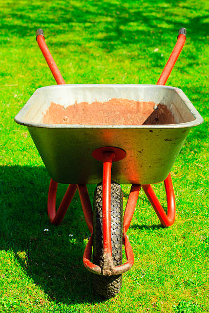 istock Gardening. Garden wheelbarrow with sand soil. 500793747