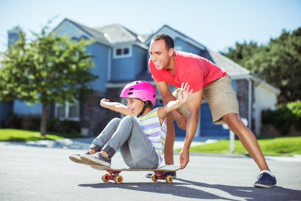 istock Father pushing daughter on skateboard 500797519