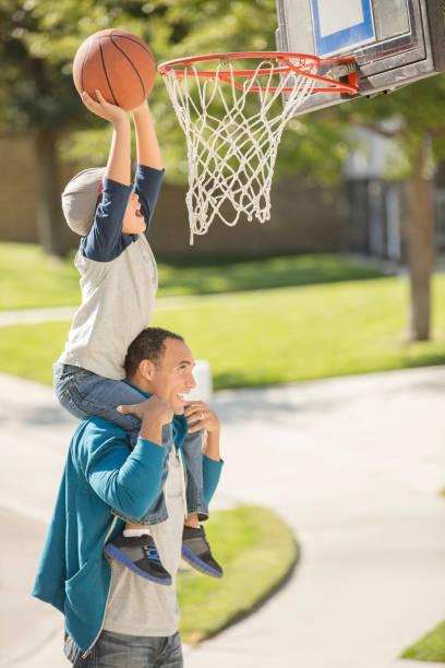 istock Father and son playing basketball in driveway 500797571
