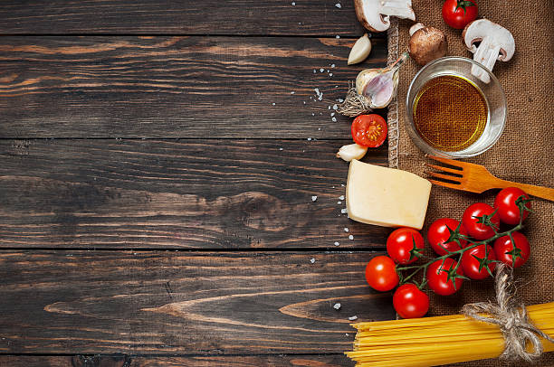 istock Pasta, tomatoes and mushrooms on wooden table background with copy 500797920