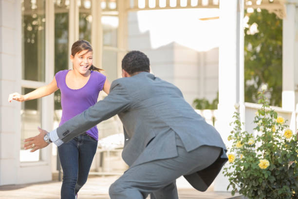 istock Daughter running to father 500797927