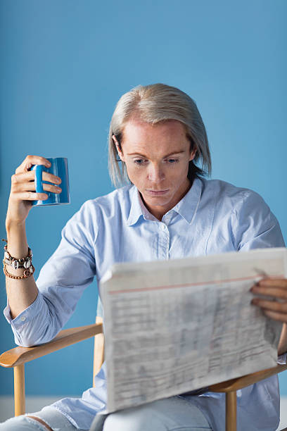 istock Fair Haired Man Reading His Morning Newspaper 500798226