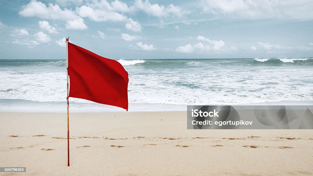 Red flag on beach  Flag Stock Photo