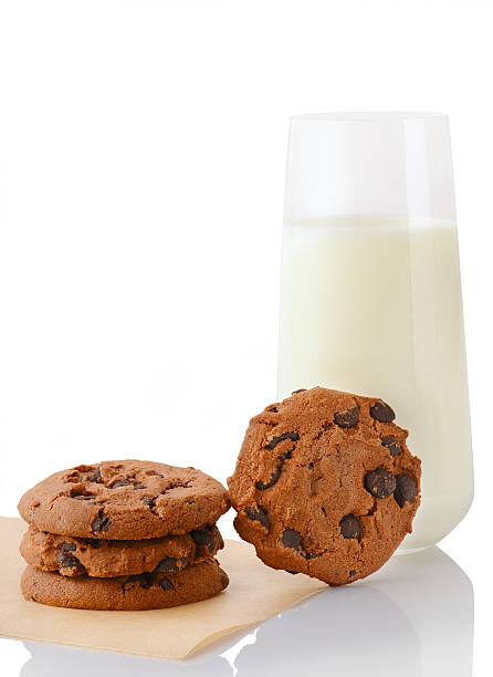 Chocolate chip cookies on paper, single cookie, glass of milk