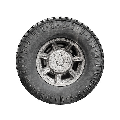 Big dirty off-road car wheel isolated on white background