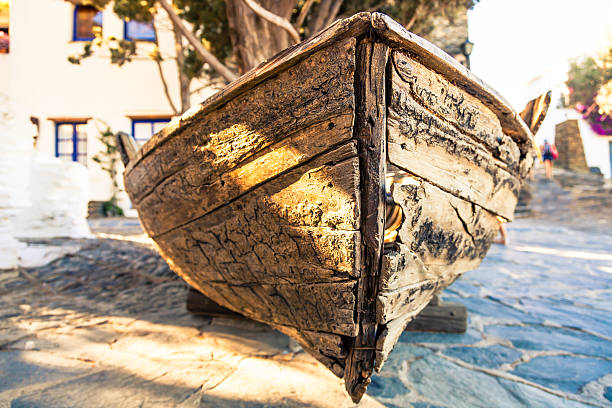 Old boat that seems like a nutshell placed in the square of small