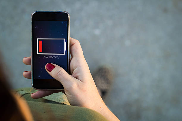 istock Woman walking smartphone low battery 500803504