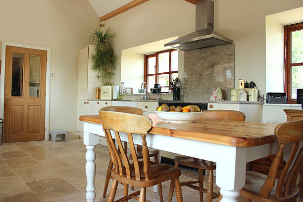 istock Country kitchen, granite worktop, gas range cooker, tiled floor, pine-table 500803589