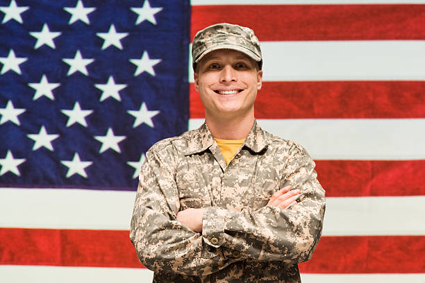 istock US soldier standing in front of American flag 500804294