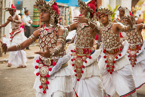 Kandy, Sri Lanka - November 25, 2015: Dancers wearing traditional dancing costume of Sri Lanka and performing in front of Sri Dalada Maligawa, also known as the temple of sacred tooth relic, during full moon day celebrations.
