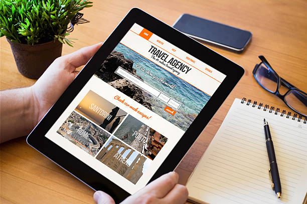 istock desktop tablet travel agency website on screen 500805528