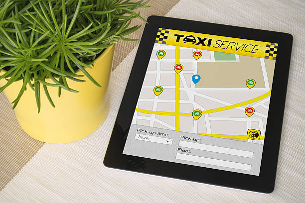 istock Tablet taxi app over a table with plant 500805830