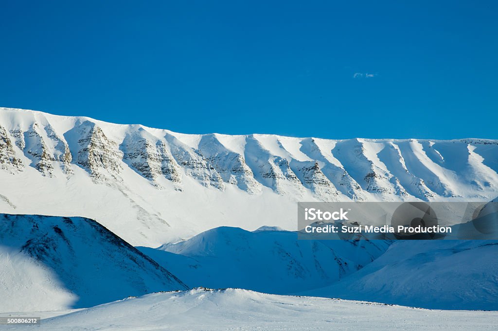 Beautiful white snowy landscape Beautiful white snowy landscape. Mountains and blue sky on the background. Sunny weather. Longyearbyen, Svalbard. 2015 Stock Photo