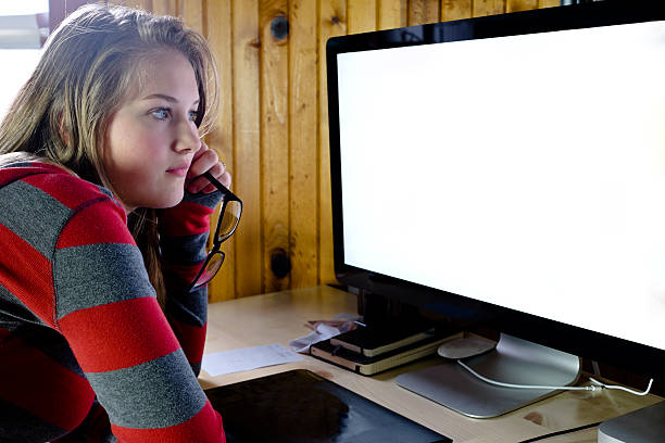 istock Young woman or teen working at a computer screen. 500806680