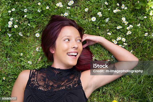 Attractive Young Woman Lying On Grass Stock Photo - Download Image Now - 20-29 Years, Adult, Adults Only