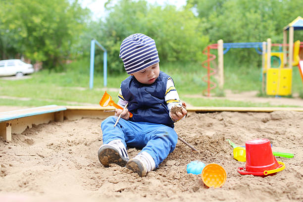 istock 21 months baby playing with sand 500807027