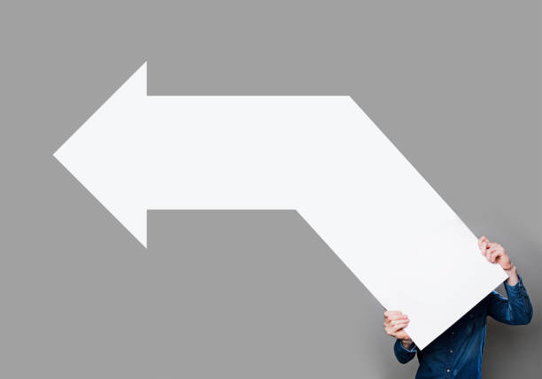 istock Man holding blank arrow sign 500807317