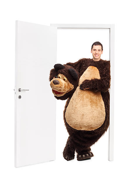 istock Man in a bear costume leaning on a door 500808816