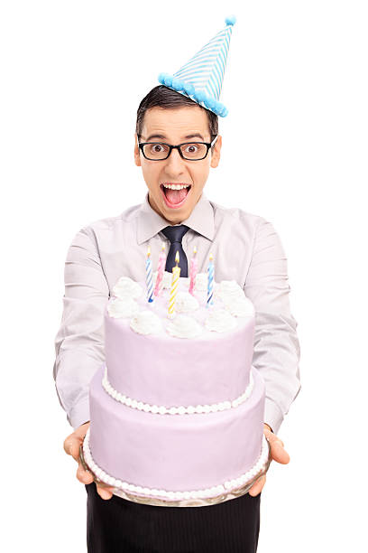 istock Young man handing a birthday cake 500808914