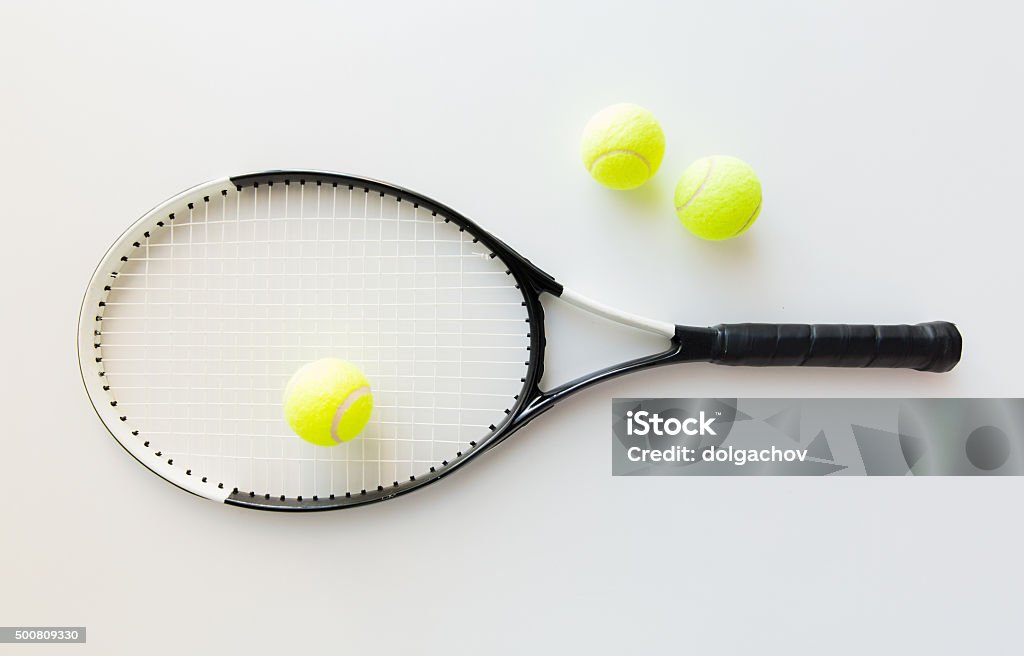 close up of tennis racket with balls sport, fitness, healthy lifestyle and objects concept - close up of tennis racket with balls Still Life Stock Photo