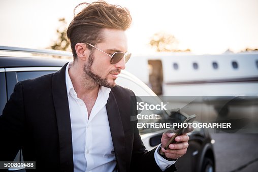 istock Man on the airport holding mobile phone 500809488