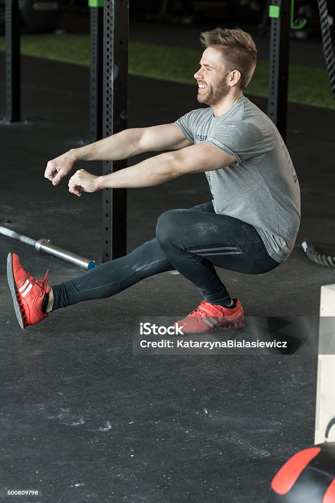 Man doing one leg squat Man doing one leg squat at the gym Men Stock Photo