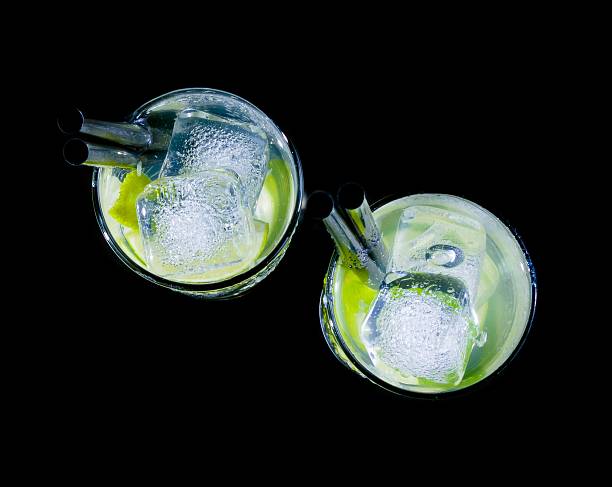 glasses with cocktail and ice with lime slice