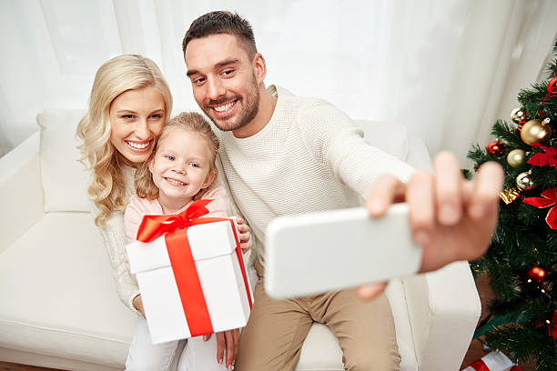 istock family taking selfie with smartphone at christmas 500811532