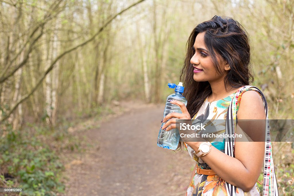 girl drinking water young woman holding a bottle of water Indigenous Peoples of the Americas Stock Photo