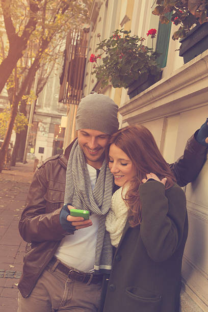 istock Couple in love using cellphone outdoors. 500812404