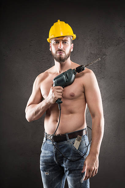 istock Portrait of attractive shirtless workman with drill 500813020