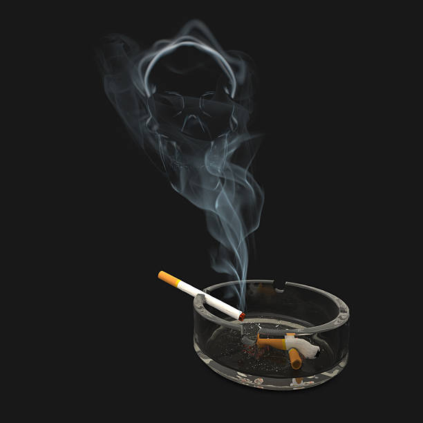 istock Ashtray with cigarette and skull inside smoke 500813410