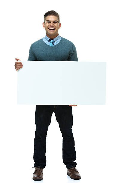 istock Happy young man standing with placard 500829195