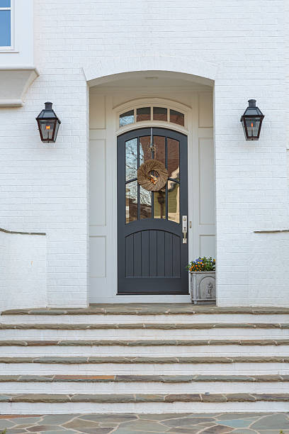 istock Blue wooden front door with wreath in daytime 500830133