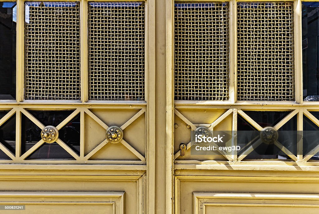 Antique door Yellow metal door with the detail in the shape of the flower in Cracow, Poland. Bronze - Alloy Stock Photo