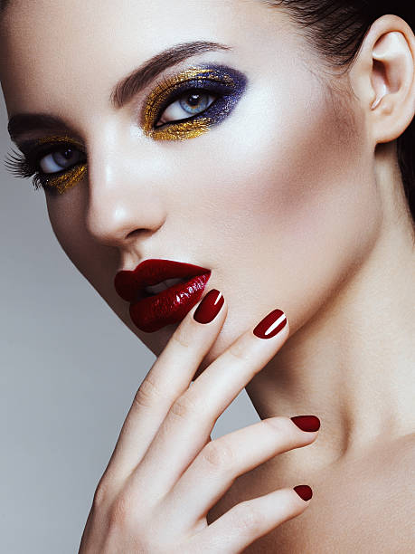 Studio beauty portrait of woman with professional make-up and manicure. High-end retouch.