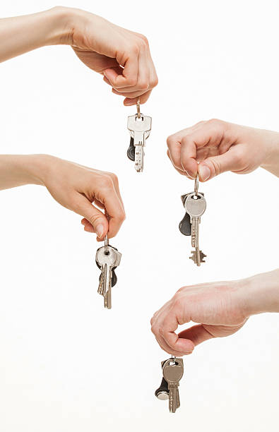 istock Four hands holding bunches of keys 500832950